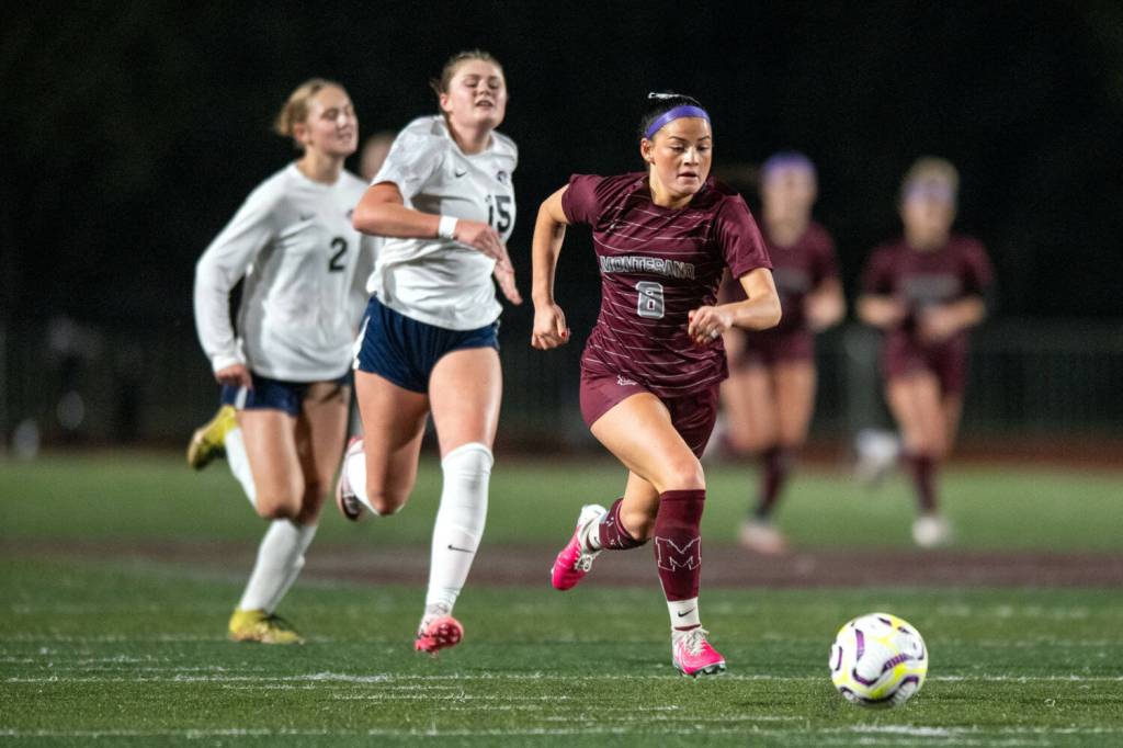 PHOTO BY FOREST WORGUM Montesano forward Adda Potts sprints away from Kings Way Christians Anna Osborne (15) and Amylia Akers during the Bulldogs 3-1 win in a 1A District 4 semifinal game on Thursday in Montesano.