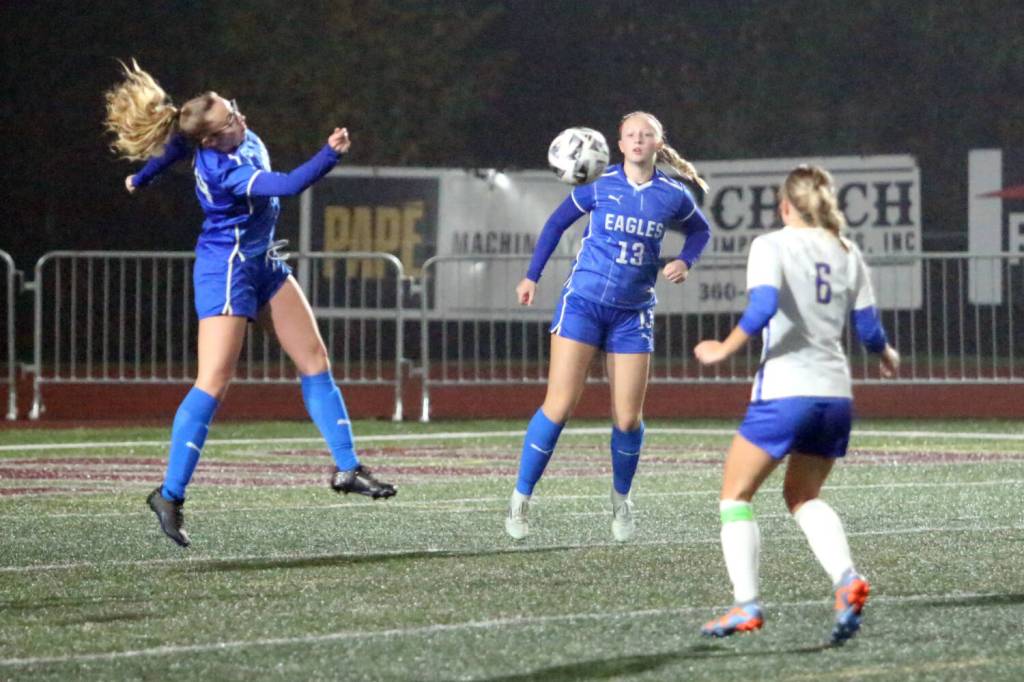 RYAN SPARKS | THE DAILY WORLD Elma defenders Chloe Donais (left) and Amaya Lewis (13) prevent the ball from getting through in a 2-0 win over Rochester in a 1A District 4 Tournament elimination game on Saturday in Montesano. The Eagles earned a berth in the state tournament with the victory.