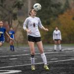 RIDLEY HUDSON | THE CHRONICLE Ocostas Kylee Denny (8) attempts a header during a 2B District 4 elimination game against Adna on Saturday at Tenino High School.
