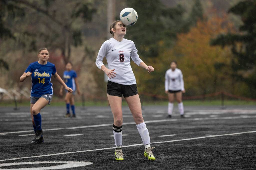RIDLEY HUDSON | THE CHRONICLE Ocostas Kylee Denny (8) attempts a header during a 2B District 4 elimination game against Adna on Saturday at Tenino High School.