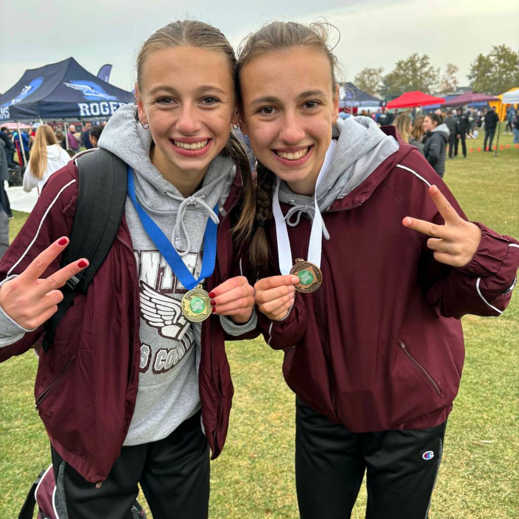 SUBMITTED PHOTO 
Montesano sisters Haley (left) and Samantha Schweppe pose for a photo after finishing first and ninth, respectively, at the WIAA 1A State Cross Country Championships on Saturday in Pasco.