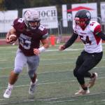 RYAN SPARKS | THE DAILY WORLD Montesanos Marcus Hale (23) sprints away from Omak linebacker Juan Duran during the Bulldogs 31-7 win in a 1A State Tournament playoff game on Saturday at Montesano High School.