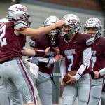 PHOTO BY FOREST WORGUM Montesano lineman Nathan Dowler (left) congratulates quarterback Tyson Perry (7) after a touchdown run during a 31-7 victory over Omak in a 1A State Tournament playoff game on Saturday at Montesano High School.