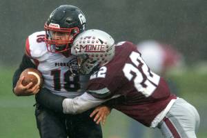 PHOTO BY FOREST WORGUM Montesano defender Ashton McKinney (22) lays a hit on Omak tight end Payton Smith during the Bulldogs 31-7 win in a 1A State Tournament playoff game on Saturday at Montesano High School.