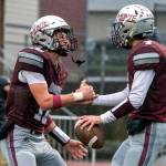 PHOTO BY FOREST WORGUM 
Montesano receiver Mason Rasmussen (left) celebrates with quarterback Tyson Perry after Perry scored a touchdown in a 31-7 win over Omak on Saturday. The Bulldogs face La Center in a 1A State quarterfinal game on Saturday at Woodland High School.