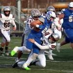 RYAN SPARKS | THE DAILY WORLD Montesano linebackers Kole Kjesbu (24) and Marcus Hale (23) tackle La Center running back Isaac Chromey during the Bulldogs 21-10 win in a 1A State Football quarterfinal game on Saturday at Woodland High School.