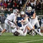 PHOTO BY FOREST WORGUM Montesano defenders Felix Romero (15), Mason Fry (8) and Kyle Caton stop Seton Catholic running back Jacob Williams short of a first down during the Bulldogs 35-14 loss in a 1A State semifinal game on Saturday in Vancouver.