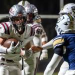 PHOTO BY FOREST WORGUM Montesanos Zach Timmons (4) carries the football against the Seton Catholic defense during the Bulldogs 35-14 loss in a 1A State semifinal game on Saturday in Vancouver.