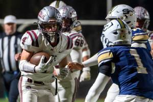 PHOTO BY FOREST WORGUM Montesanos Zach Timmons (4) carries the football against the Seton Catholic defense during the Bulldogs 35-14 loss in a 1A State semifinal game on Saturday in Vancouver.