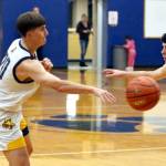 RYAN SPARKS | THE DAILY WORLD Aberdeen junior guard Floyd Jones (left) makes a pass during an 85-50 loss to R.A. Long on Tuesday at Sam Benn Gym in Aberdeen.
