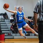 PHOTO BY FOREST WORGUM Elmas Olivia Moore leaps to save the ball during a 56-27 loss to Raymond-South Bend on Thursday at Raymond High School.