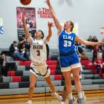 PHOTO BY FOREST WORGUM Raymond-South Bend guard Megan Kongbouakhay (3) drives to the hoop against Elmas Olivia Moore during the Ravens 56-27 win on Thursday in Raymond.