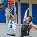 PHOTO BY FOREST WORGUM Elmas Isaac McGaffey (3) dunks against Raymond-South Bends Chris Banker during the Eagles 67-62 victory on Friday in Elma.