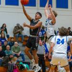 PHOTO BY FOREST WORGUM Raymond-South Bends Chris Quintana (left) scores two of his game-high 28 points in a 67-62 loss to Elma on Friday at Elma High School.
