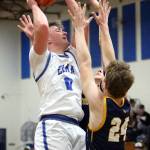RYAN SPARKS | THE DAILY WORLD Elma senior guard Traden Carter (0) is defended by a pair of Forks Spartans during a 67-48 loss to Forks on Friday at Elma High School.