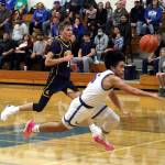 RYAN SPARKS | THE DAILY WORLD Elma senior guard Theo Flores (right) is tripped up from behind during a 67-48 loss to Forks on Friday in Elma.