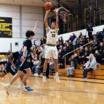 PHOTO BY MATT CYPHERT North Beachs Jeremiah Eastman (30) puts up a jump shot during a 45-39 win over Northwest Christian on Saturday at North Beach High School.