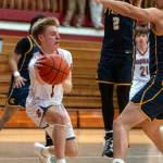 PHOTO BY FOREST WORGUM Hoquiam guard Ryker Maxfield (left) looks to pass during a 62-39 loss to Forks on Monday at Hoquiam Square Garden.