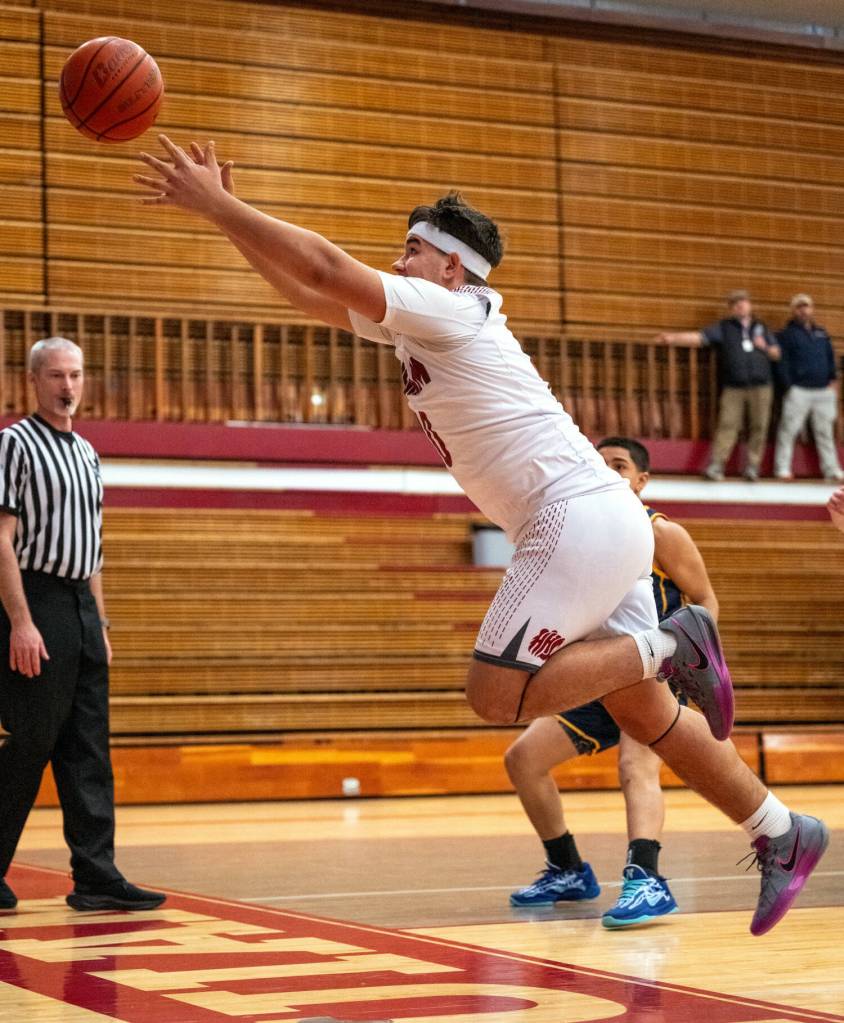 PHOTO BY FOREST WORGUM Hoquiams Ryan Pullar leaps in an attempt to save a loose ball during a 62-39 loss to Forks on Monday at Hoquiam High School.