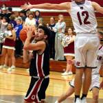 RYAN SPARKS | THE DAILY WORLD Ocosta guard Jesus Agramon (left) avoids the block attempt of Hoquiams Tage Dayton (12) during the Wildcats 55-39 victory on Thursday at Hoquiam Square Garden.