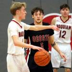 RYAN SPARKS | THE DAILY WORLD Ocostas Noah Prigmore defends Hoquiams Ryker Maxfield (left) during the Wildcats 55-39 victory on Thursday at Hoquiam Square Garden.