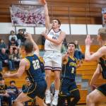 PHOTO BY FOREST WORGUM Montesano guard Terek Gunter puts up a shot against Forks Brody Lausche (22) and Noah Foster (2) during the Bulldogs 58-51 loss on Friday at Montesano High School.
