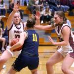 PHOTO BY HAILEY BLANCAS Montesanos Tieander Olson (left) and Regan Wintrip trap Forks Brooklynn Rondeau during the Bulldogs 40-23 victory on Friday at Montesano High School.