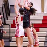 PHOTO BY HAILEY BLANCAS Montesano forward Jillie Dalan (24) shoots over Mossyrocks Chesney Schultz during the Bulldogs 43-30 win on Monday at Mossyrock High School.