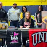 SUBMITTED PHOTO Aberdeen senior Felicia Bell (sitting) signed a National Letter of Intent to wrestle for the University of Nevada, Las Vegas at a ceremony at Aberdeen High School on Friday. Bell placed third in the state meet last season and currently has 100 wins in her prep career, the most of any Bobcat female wrestler in school history. Pictured behind Bell are (from left) father Don Bell, coaches Craig and Tamar Yakovich, and mother Michele Bell.