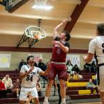 PHOTO BY FOREST WORGUM Hoquiam guard Joey Bozich (4) shoots over Raymond-South Bends Fernando Jiminez during the Grizzlies 57-44 win in the Raymond New Years Tournament on Saturday at South Bend High School.