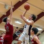 PHOTO BY FOREST WORGUM Raymond-South Bends Chris Banker (2) puts up a shot against Hoquiams Tage Dayton during the Grizzlies 57-44 win on Saturday at South Bend High School.