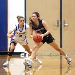 PHOTO BY HAILEY BLANCAS Montesanos Makena Blancas (right) looks to pass against Kelsos Madalynn Moe during the Bulldogs 43-30 win at the Adna Holiday Tournament on Saturday at Adna High School.