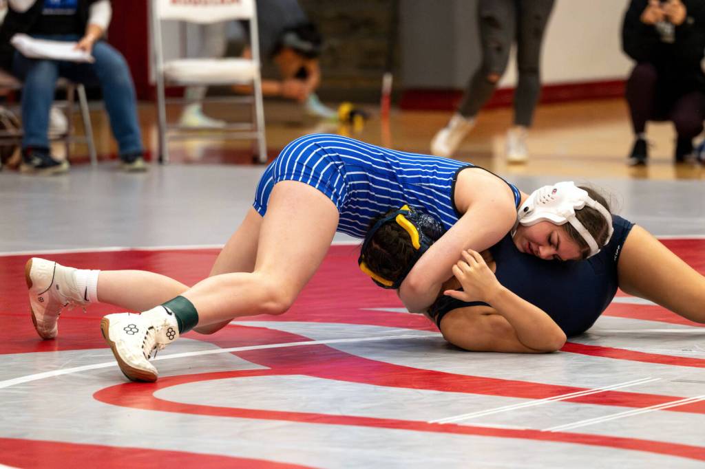 PHOTO BY FOREST WORGUM Elmas Olivia Mason (left) placed third overall in the 115-pound weight class at the Grizzly Stocking Stuffer wrestling tournament on Saturday at Hoquiam High School.