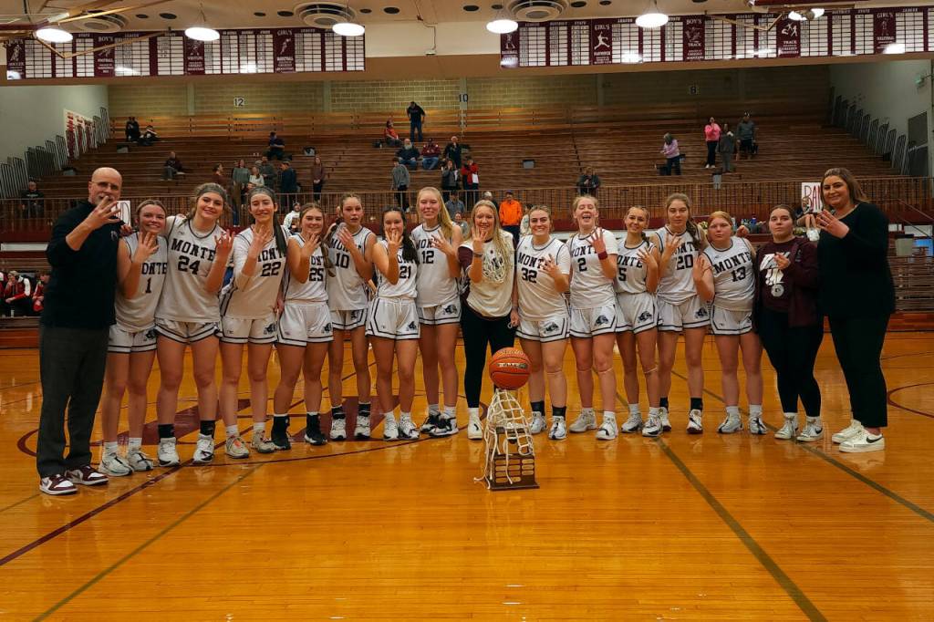 DAILY WORLD FILE PHOTO The Montesano Bulldogs pose with the 1A District 4 championship trophy after defeating Seton Catholic 41-36 in February at Hoquiam High School. The Bulldogs won the title for the fourth-straight season.