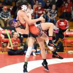 PHOTO BY SUE MICHALAK BUDSBERG Elmas Aidyn Johnson (left) throws Castle Rocks Kacen Hamilton in the 120-pound final of the Jim Bair Invitational on Saturday at Castle Rock High School.