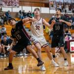 PHOTO BY FOREST WORGUM Raymond-South Bends Juan Sanchez Martinez (15) and Juan Orozco (10) compete for a rebound against Montesanos Nathan Dowler during the Bulldogs 57-40 win on Monday in Montesano.