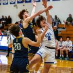 PHOTO BY MIKE ROBERTS Elmas Tanner Moe (2) is fouled on a drive to the basket during the second half of the Eagles 57-49 win over Aberdeen on Monday in Elma. Aberdeens Gabe Matthews and Floyd Jones (20) defend on the play.