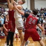 PHOTO BY FOREST WORGUM Montesanos Caden Grubb (middle) puts up a contested shot during the Bulldogs 54-45 victory over Hoquiam on Wednesday in Montesano.