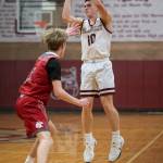 PHOTO BY FOREST WORGUM Montesano guard Terek Gunter shoots a 3-pointer while defended by Hoquiams Ryker Maxfield during the Bulldogs 54-45 victory on Wednesday at Montesano High School.