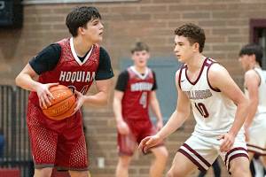 PHOTO BY FOREST WORGUM Hoquiam guard Lincoln Niemi (left) is defended by Montesano guard Terek Gunter during the Bulldogs 54-45 victory on Wednesday at Montesano High School.