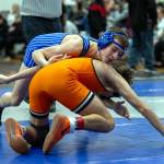PHOTO BY FOREST WORGUM Elmas Aidyn Johnson (top) competes in the 120-pound weight class during the Sgt. Justin Norton Memorial Invitational on Saturday at Rainier High School.