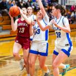 PHOTO BY MIKE ROBERTS Hoquiams Katlyn Brodhead (13) drives to the basket while Elmas Olivia Moore (33) and Emily Escoffon defend during the Grizzlies 49-27 win on Tuesday in Elma.