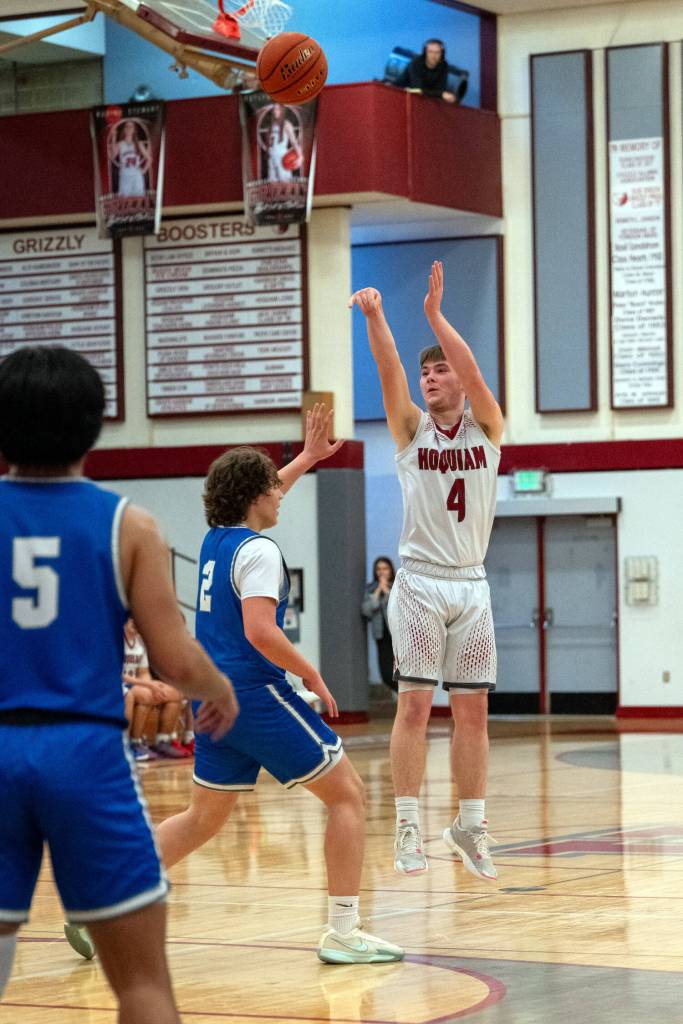 PHOTO BY FOREST WORGUM Hoquiams guard Joey Bozich (4) shoots a three against Elmas Tanner Moe (2) during the Grizzlies 56-46 loss on Wednesday at Hoquiam Square Garden.