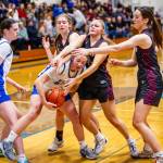 PHOTO BY MIKE ROBERTS Elma junior Olivia Moore is swarmed by Montesano defenders (from left) Hazel Jones, Josie Forster and Ava Schrader during the Bulldogs 40-21 win on Thursday at Elma High School.