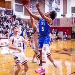 PHOTO BY MIKE ROBERTS Elmas Theo Flores (5) glides to the hoop against Montesanos Nathan Dowler (32) during the Bulldogs 47-33 victory on Friday at Montesano High School.