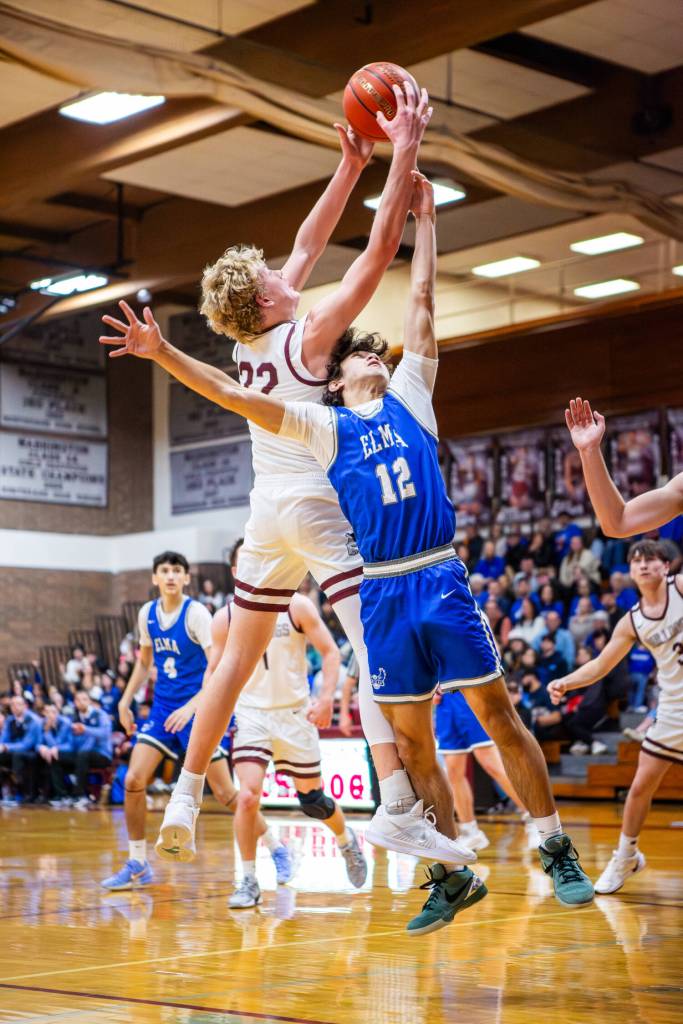 PHOTO BY MIKE ROBERTS Montesanos Mason Fry (left) grabs a rebound over Elmas Armani Phan during the Bulldogs 47-33 victory on Friday at Montesano High School.