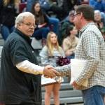 PHOTO BY FOREST WORGUM Montesano head football coach Terry Jensen (left) is congratulated by South Sound Football Officials Association President Jeff Gottlieb during a ceremony on Friday at Montesano High School. The Bulldogs were awarded with the SSFOAs sportsmanship scholarships for the 2024 season.
