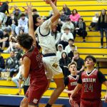 RYAN SPARKS | THE DAILY WORLD Aberdeen guard Isaac Garcia (middle) scores on a layup against Hoquiams Talan Abbott (21) during a 66-61 win on Monday in Aberdeen.