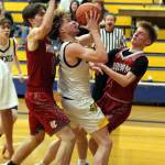RYAN SPARKS | THE DAILY WORLD Aberdeens Tarren Lewis (middle) drives to the basket against Hoquiams Tage Dayton (left) and Ryker Maxfield in the Bobcats 66-61 victory on Monday in Aberdeen.