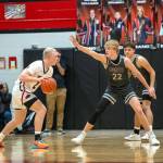 PHOTO BY FOREST WORGUM Montesanos Mason Fry (22) guards Teninos Austin Gonia during the Bulldogs 43-28 loss on Monday in Tenino.